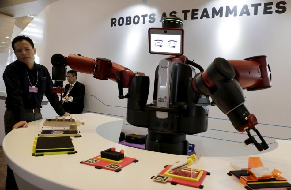 A Baxter robot from Rethink Robotics picks up a business card as it performs during a display at...