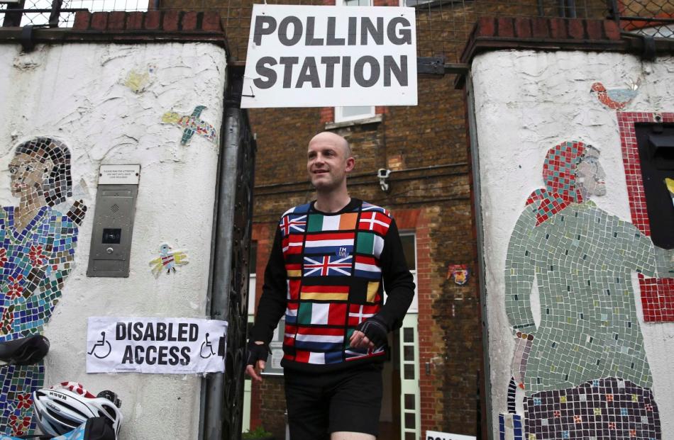 A man wearing a European themed cycling jersey leaves after voting at a polling station for the...