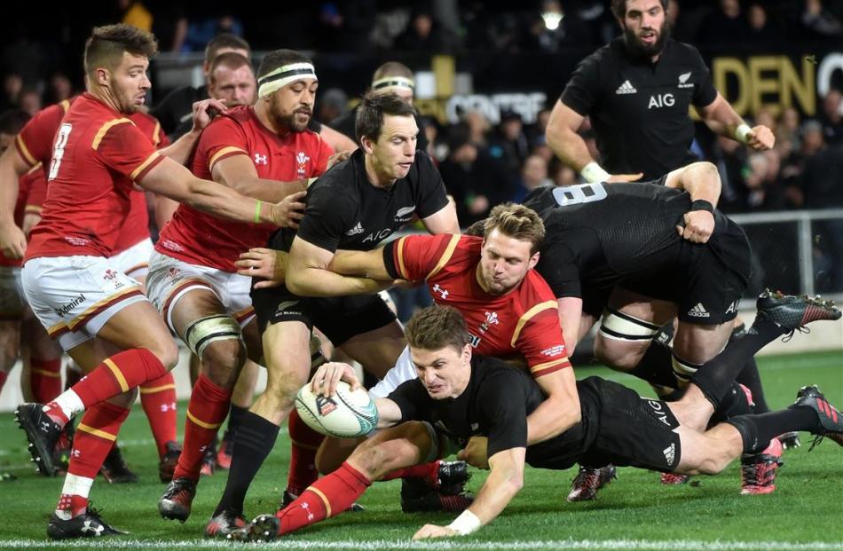 All Blacks first five-eighth Beauden Barrett muscles his way over the line in the tackle of his...