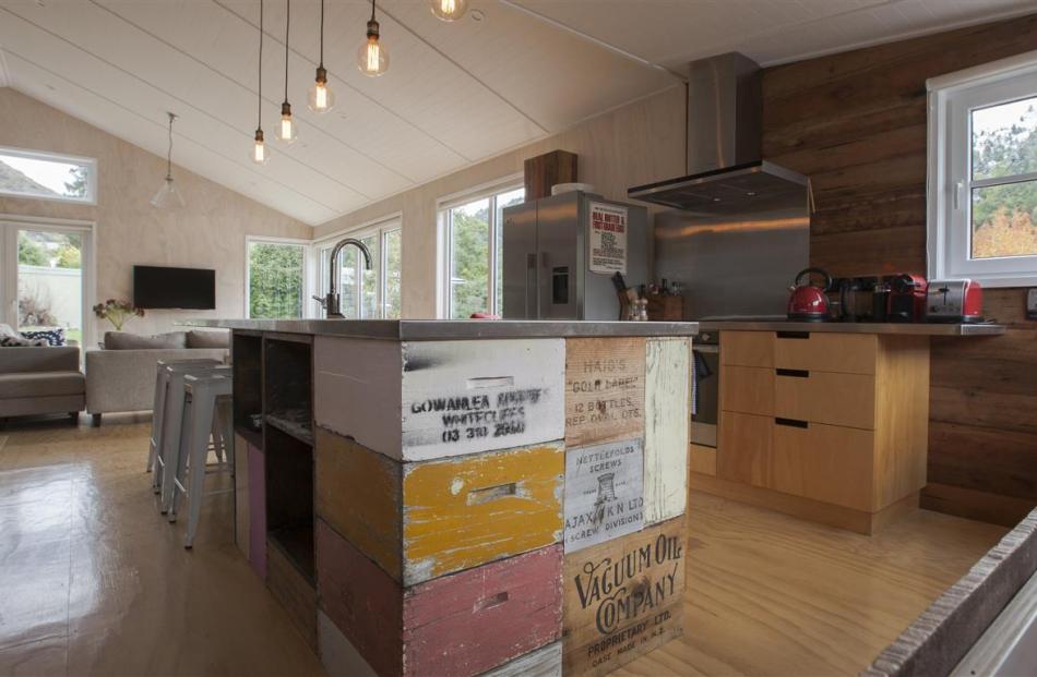 Bee boxes and whisky cases are built into the kitchen bench in this Arrowtown holiday home....