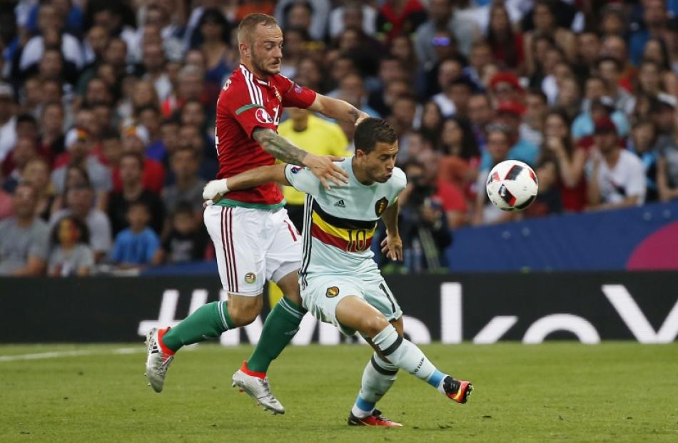 Eden Hazard (white) in action with Hungary's Gergo Loverencsics. Photo: Reuters