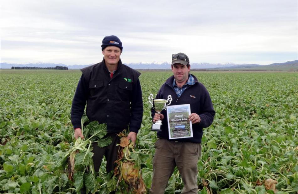 Johnny Duncan (left) and Shane Lyon stand in the overall prize-winning crop in the Maniototo...