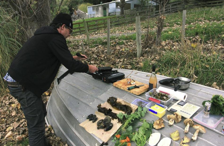 Peter Langlands prepares to cook up the day’s finds from a foraging expedition. Photos: supplied