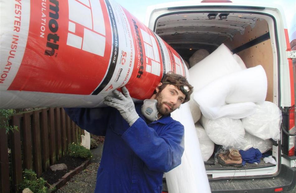 Smart Energy Solutions insulation installer Brett Murphy, of Dunedin, prepares to install 200mm...