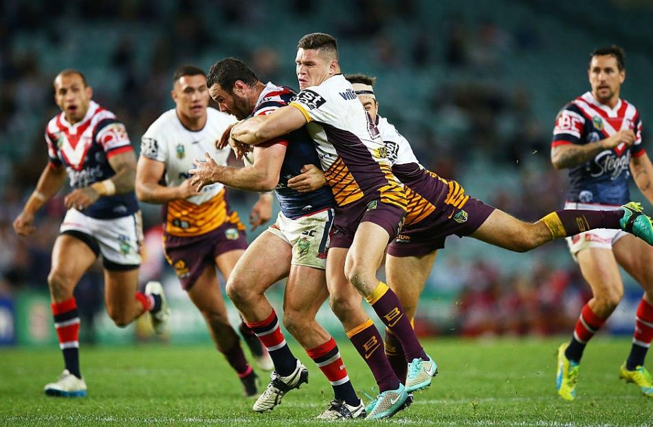 Broncos players try to bring down Boyd Cordner of the Sydney Roosters. Photo: Getty Images