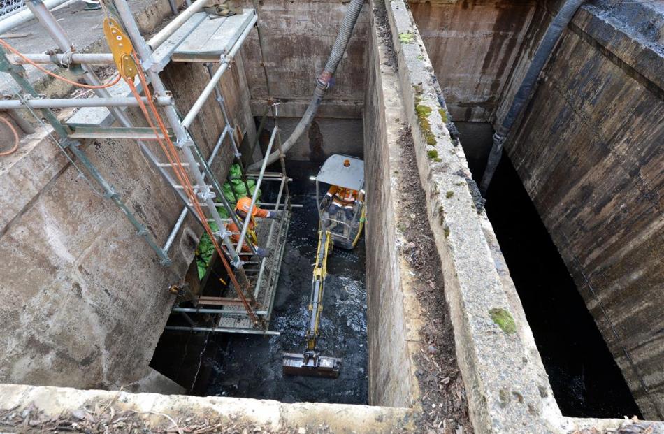 Contractors remove sediment and debris in preparation for a new screen to be installed at Dunedin...