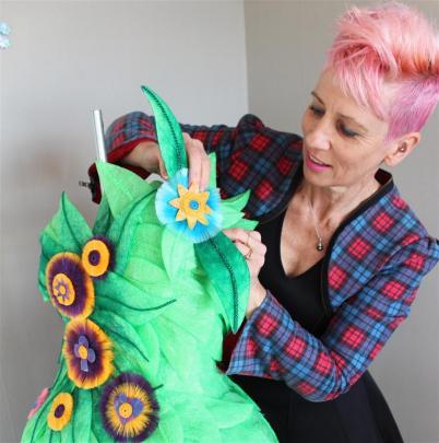 Designer Jennie Hasler-Jacobs puts the final touches to one of her designs,  not one she is...
