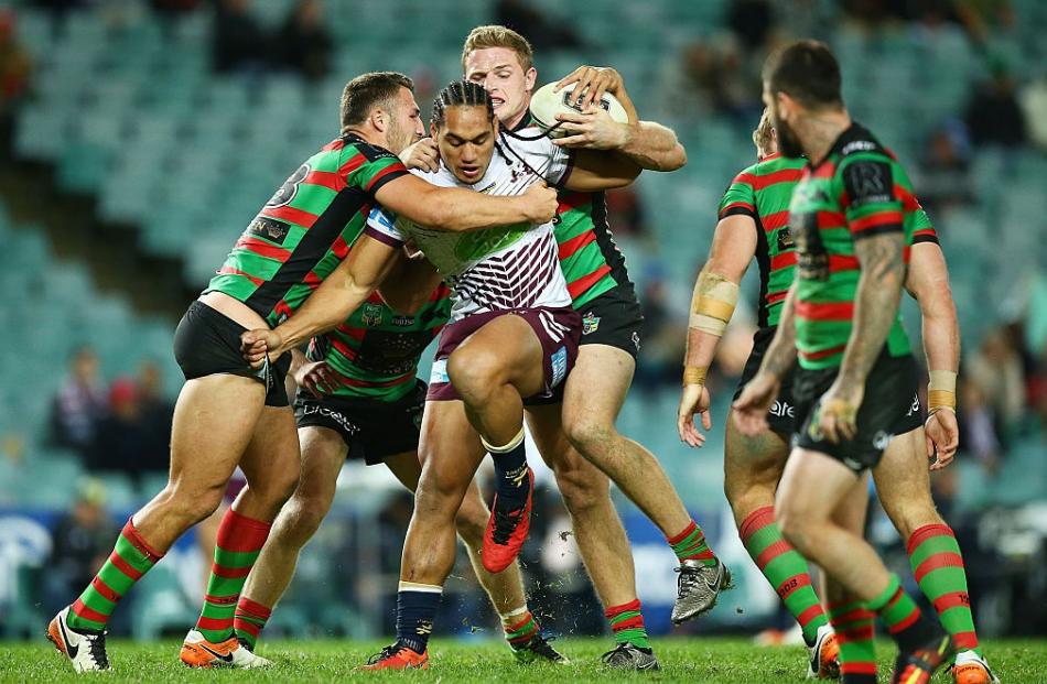 Manly forward Martin Taupau is tackled by Sam and George Burgess. Photo: Getty Images