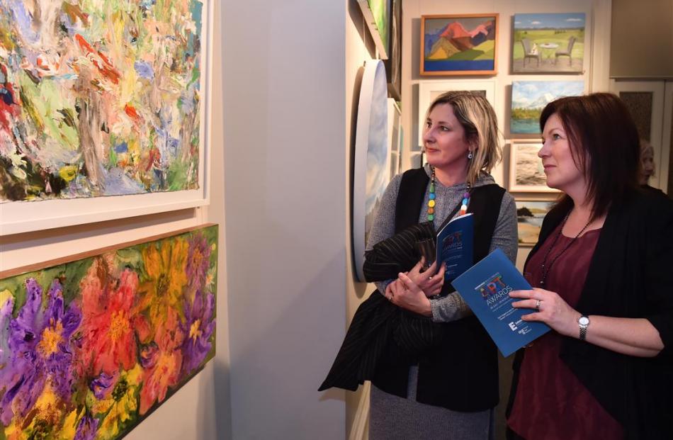 Megan Struthers (left) and Sandy Bisset, both of Mosgiel, study an untitled acrylic work by...