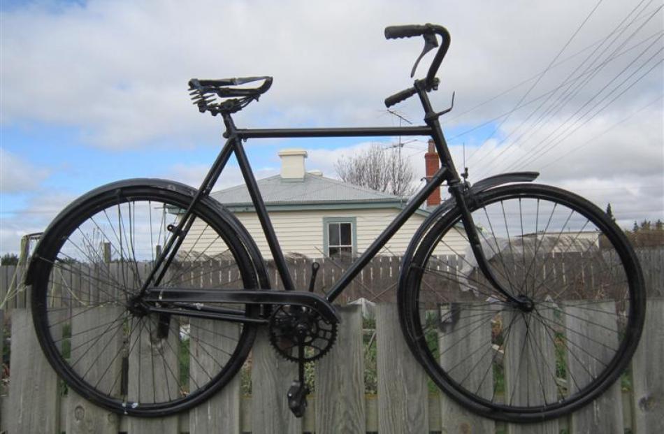 The painted bicycle art work Growing Cycle displayed on a fence at Grocott's Community Garden in...