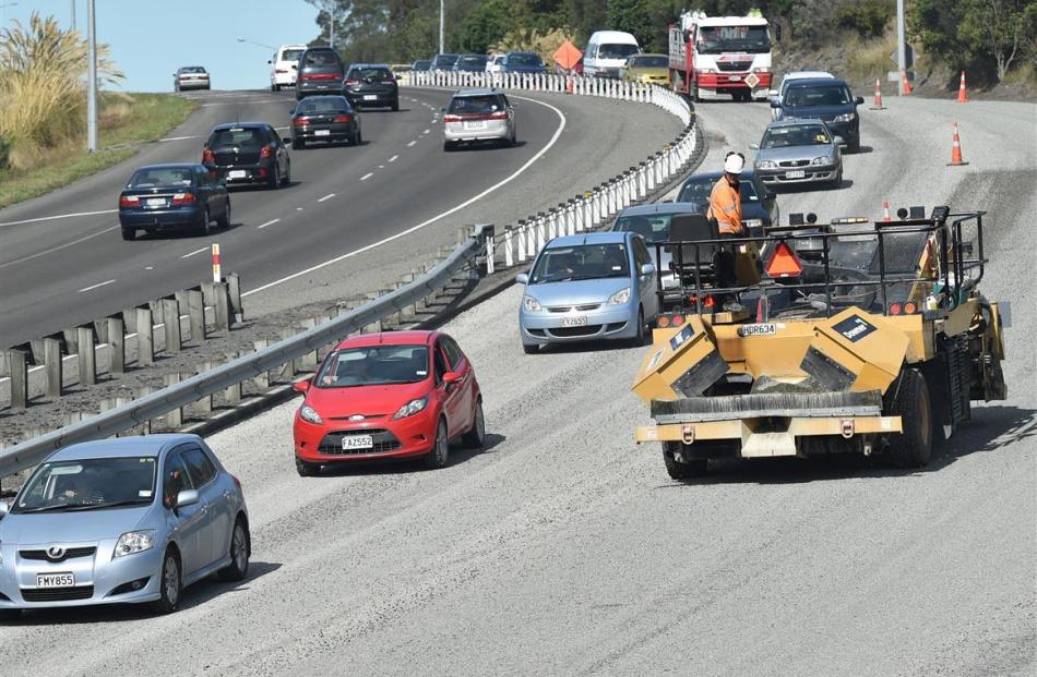 Downer staff work on the resealing the Southern Motorway at Saddle Hill last month. Photo by...