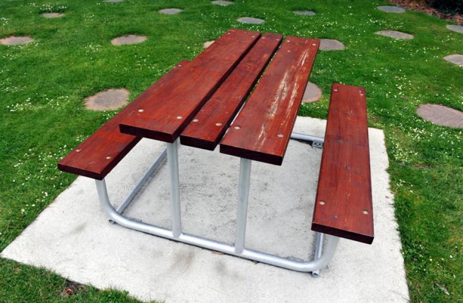 The picnic table set to stay near the Falling Leaves sculpture on the corner of Gordon and...