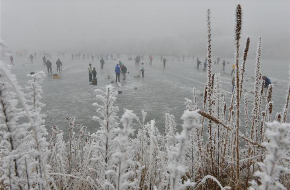 Curlers at the national Bonspiel spread across the frozen Idaburn Dam yesterday. Photos by Peter...