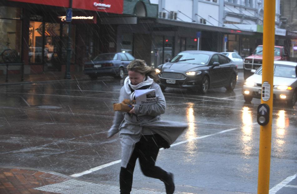 Running through the rain in Stuart Street today. Photo: Christine O'Connor