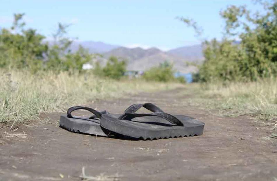 Still life . . . A pair of Jandals sits on the shore of Lake Benmore. Photo: Kourtney Rogers (15)