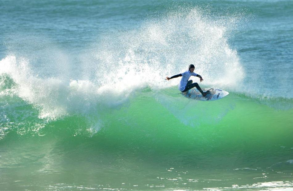 Taranaki surfer Jarred Hancox tackles the surf and  braves  the rocks on St Clair Beach during...