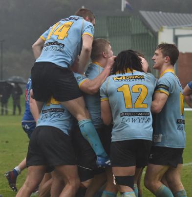 University players celebrate their win over Harbour in the semifinal at the University Oval on...