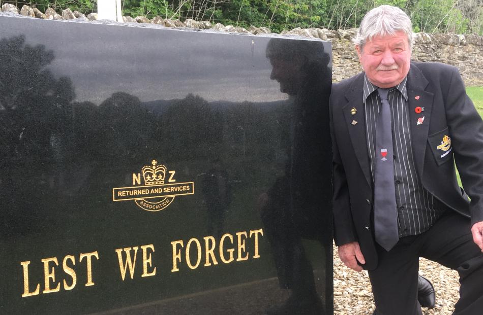 RSA Otago Southland District vice-president Kevin Harding admires a new plaque at Clyde Cemetery...