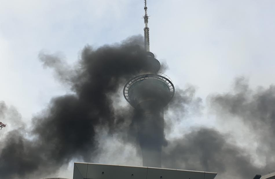 The Sky Tower partially obscured by smoke from the fire. Photo: RNZ
