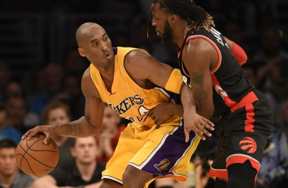 Lakers guard Kobe Bryant posts up Raptors forward DeMarre Carroll in a recent game at the Staples...