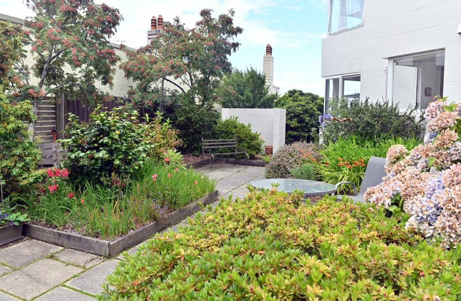 Mature rhododendrons, hydrangeas and roses feature in the shared garden. Mrs Angelo-Roxborough...