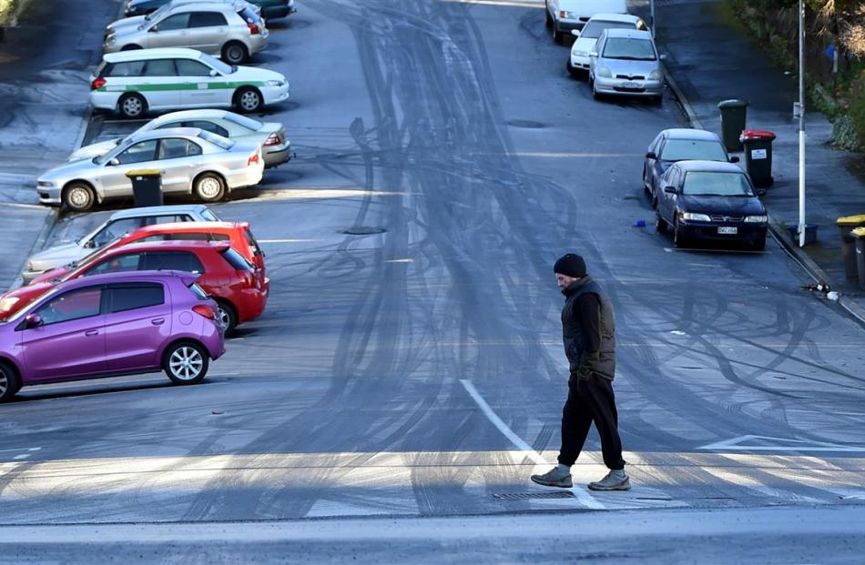 A man crosses an icy Union St in Dunedin yesterday.  Photo by Peter McIntosh.