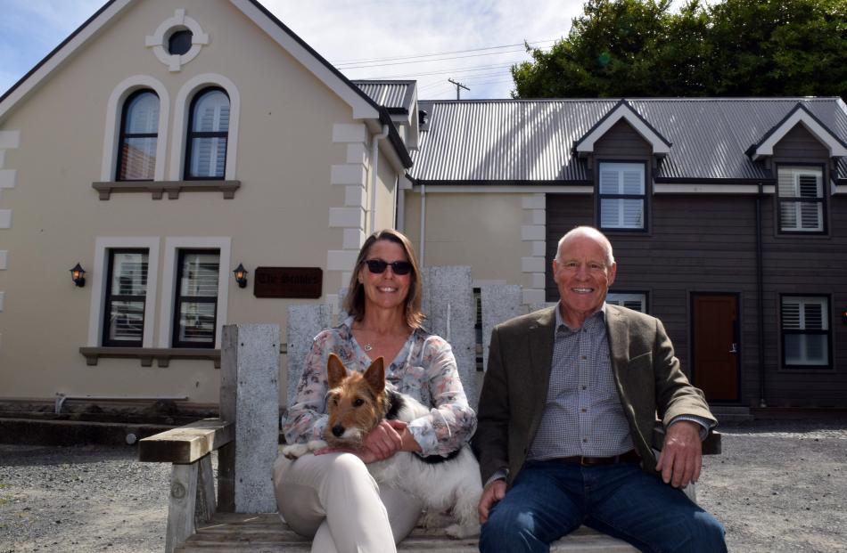 The Stables owners Caryn Bouton and Malcolm McDonald and her foxy-cross dog Dexter relax at the...