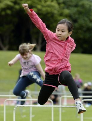 Grace Wong (9) shows great style in the hurdles.