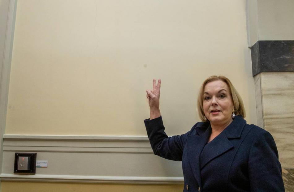 National leader Judith Collins mimics Churchill's V for Victory sign, beside the wall where his...