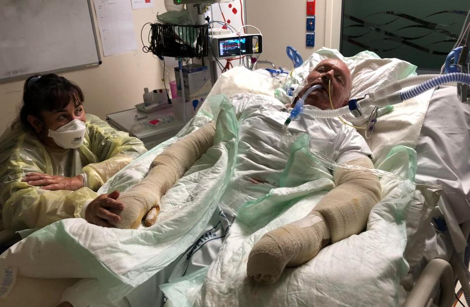 Kevin Burney’s wife Amanda at his side in Middlemore Hospital where he is recovering after...