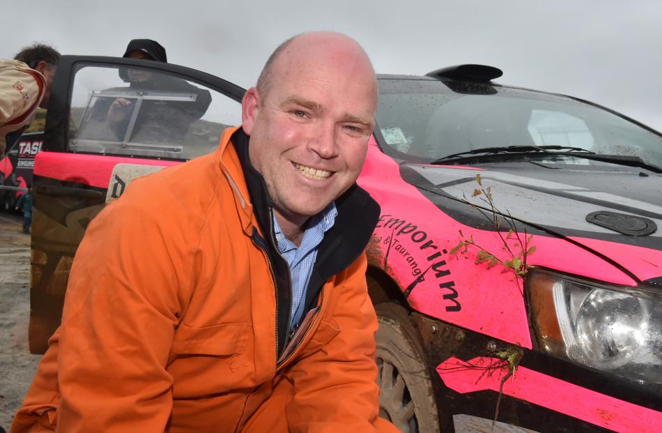 Otago Daily Times reporter Shawn McAvinue inspects  some bush caught in the front of the...