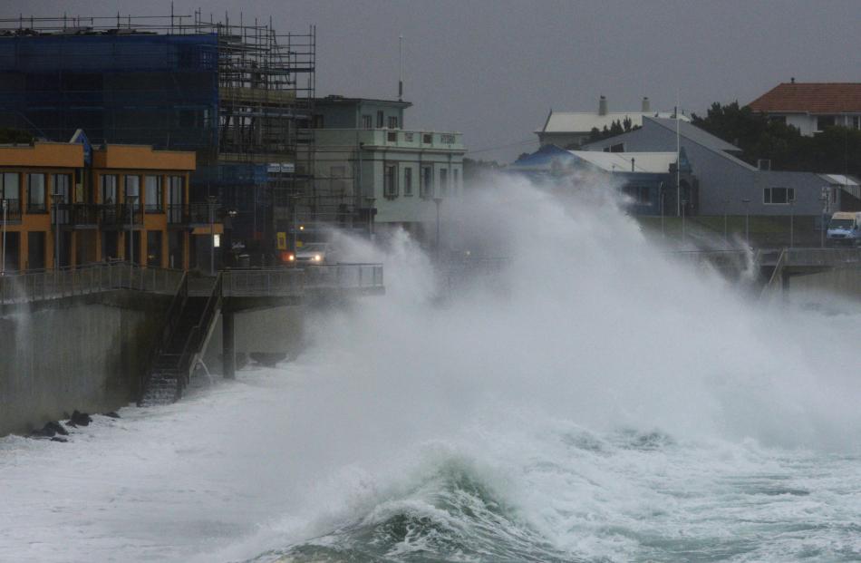 High seas lash cars driving on the St Clair Esplanade this afternoon. Photo: Gerard O'Brien