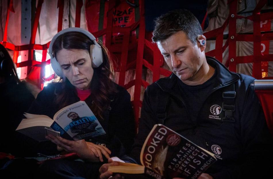 Prime Minister Jacinda Ardern and fiancé Clarke Gayford aboard the RNZAF C130 bound for...