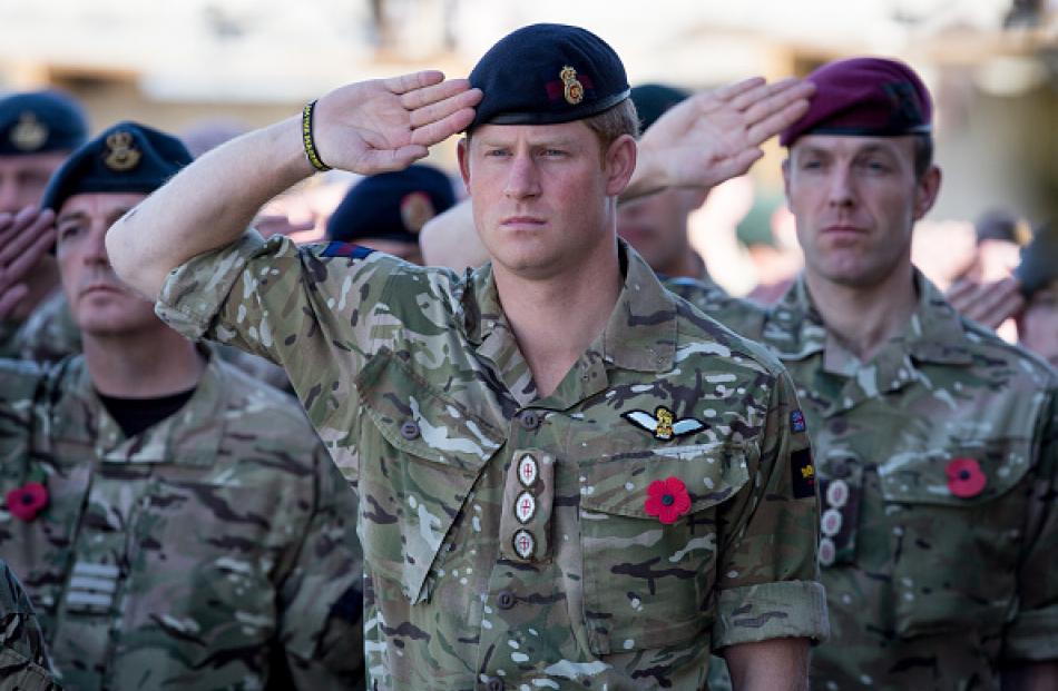 Prince Harry salutes as the Last Post is played in Afghanistan. Photo: Matt Cardy/Getty Images
