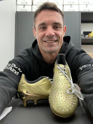 Dan Carter with a pair of his limited edition Adidas boots. Photo: Supplied