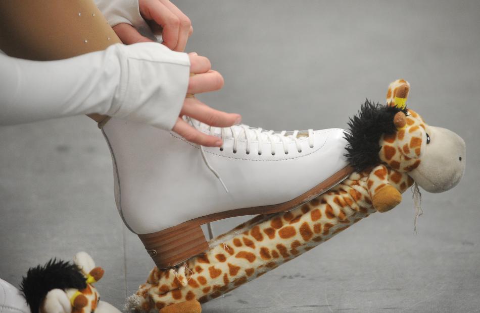 Tying up the skates during time off the ice.