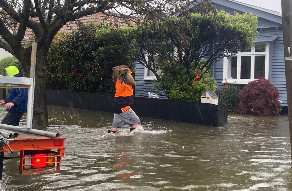 Sandbagging in Cranley St, Tainui. Photo: Craig Baxter