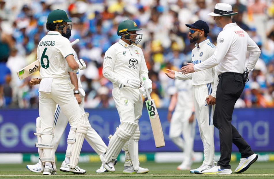 Virat Kohli chats with Australia's Sam Konstas and Usman Khawaja after the incident on day one of...
