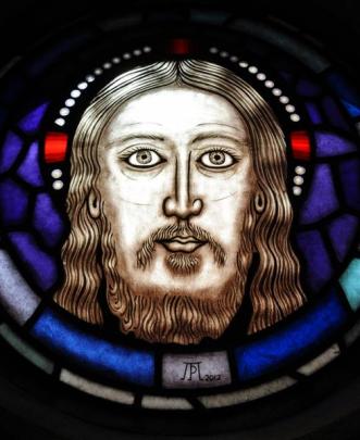 Jesus Christ has central place at the top of the tracery.
