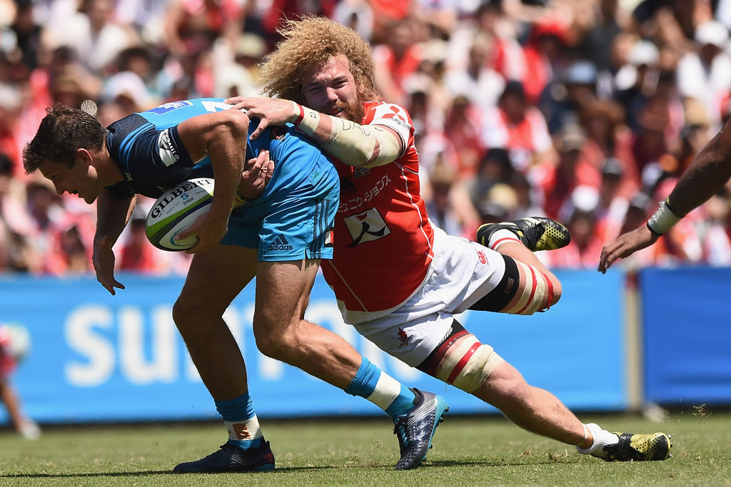 Matt Duffie of the Blues is tackled by Willie Britz of the Sunwolves. Photo: Getty