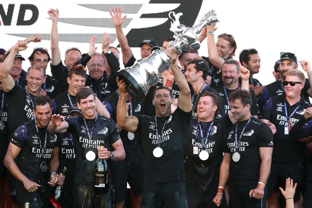 Emirates Team NZ celebrate with the "Auld Mug" trophy after successfully defending the America's...