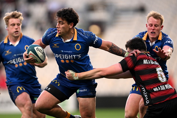 Otago second five Thomas Umaga-Jensen attempts to fend off Canterbury lock Jamie Hannah during...