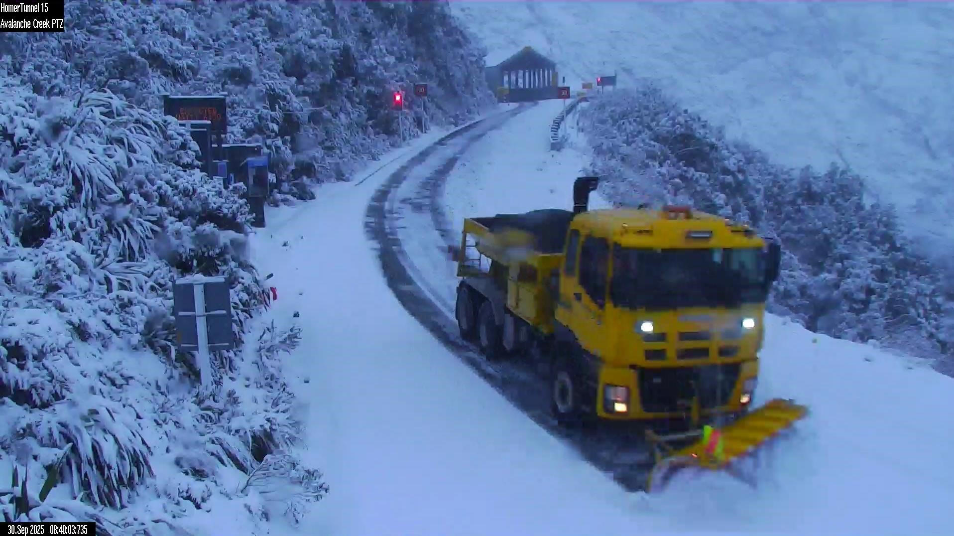 Milford Road being cleared ahead of a temporary opening for essential travel this morning. Photo:...