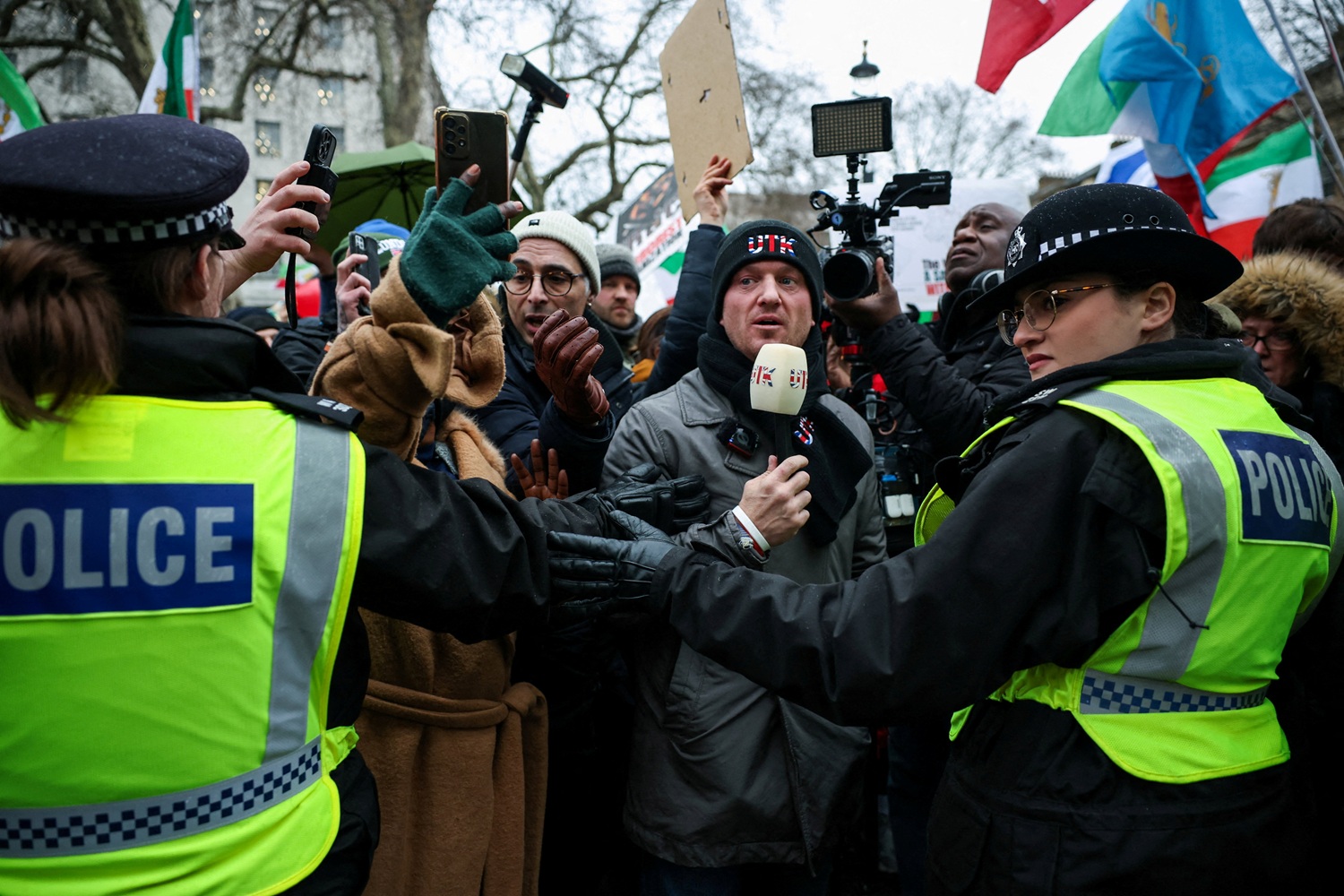 Activist Stephen Yaxley-Lennon, known as Tommy Robinson, wears a \"United The Kingdom\" (UTK)...