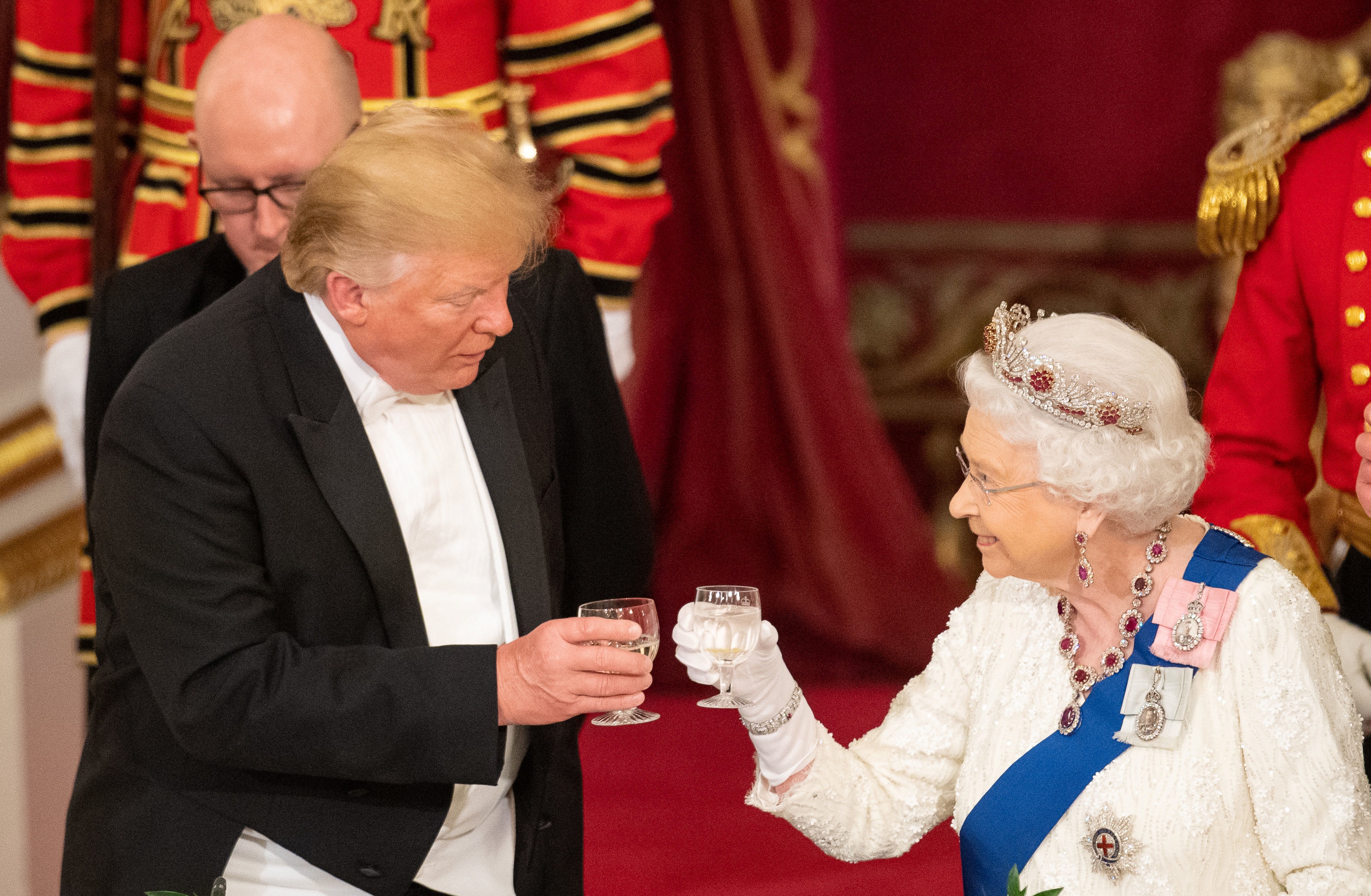 Donald Trump and the Queen raise their glasses to make a toast at the State Banquet at Buckingham...