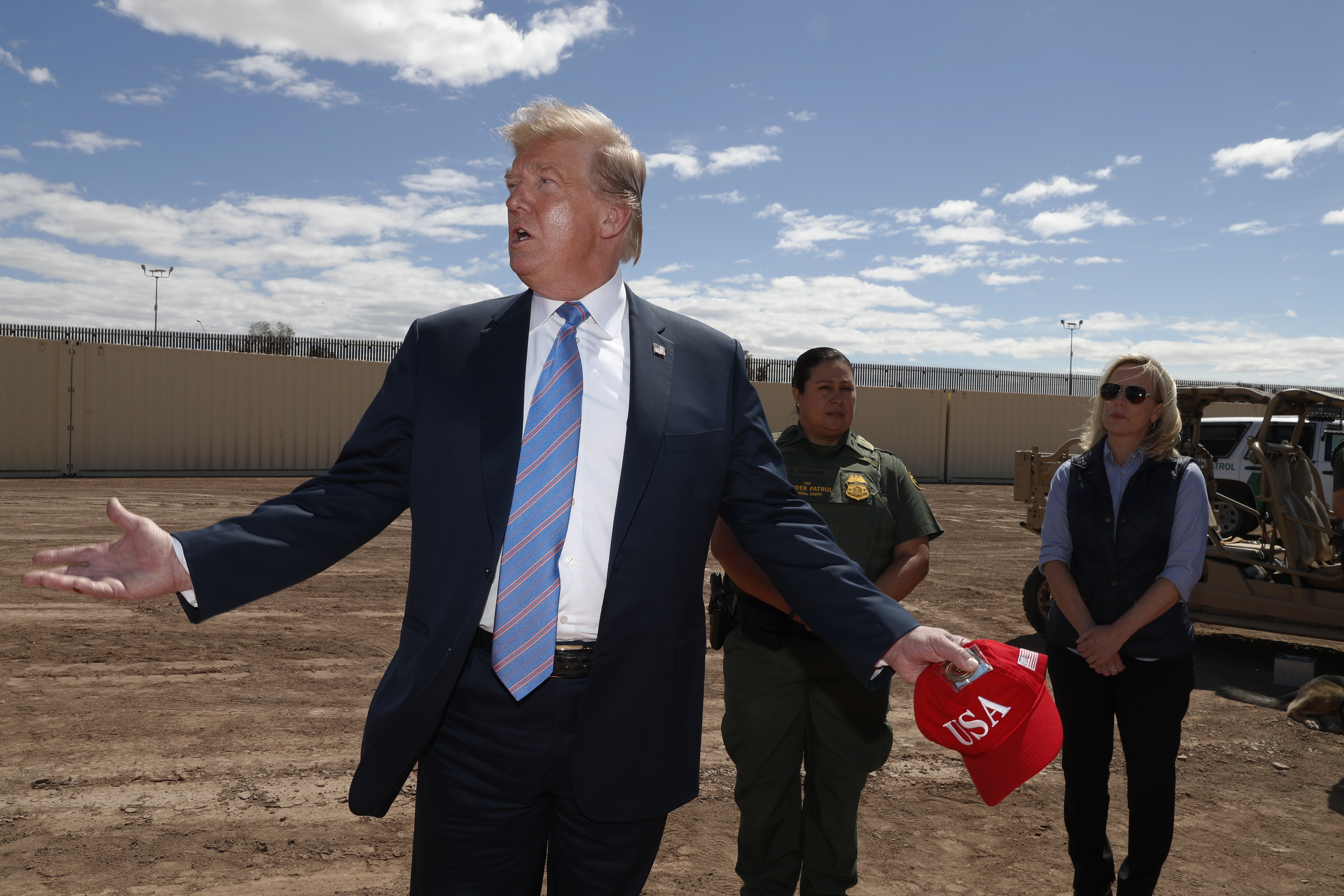 President Donald Trump visits a new section of the border wall with Mexico in Calexico,...