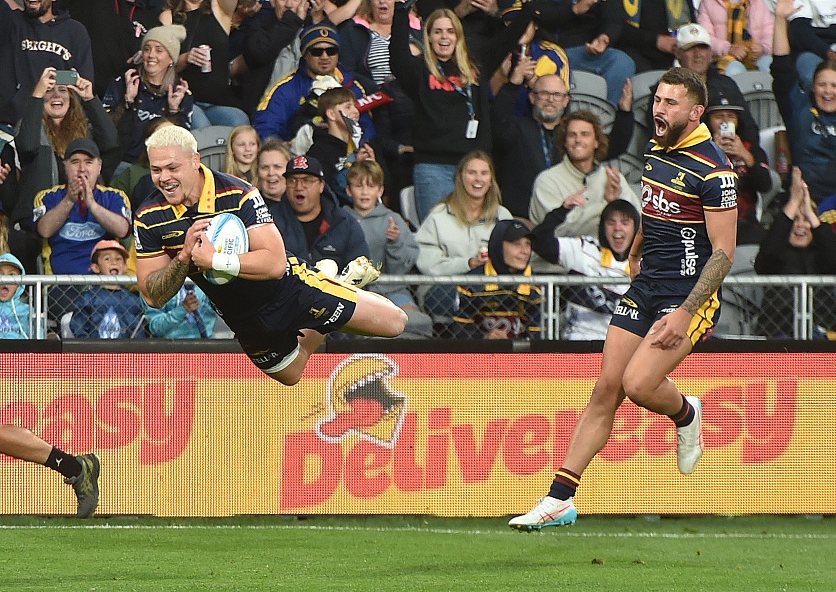 Caleb Tangitau flies high to score the Highlanders’ opening try as team-mate Jacob Ratumaitavuki...