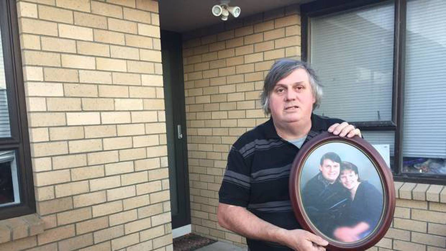 Laurie Anderson holds a photo of him with partner Angela Blackmoore who was murdered in 1995 just...