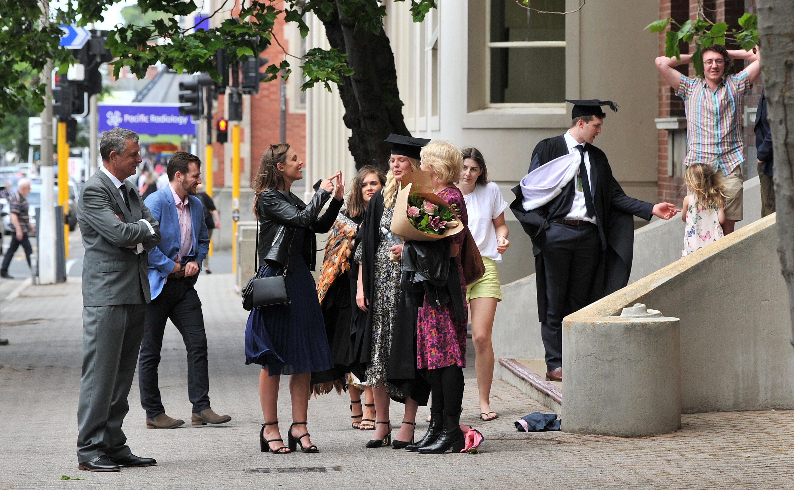 A student is comforted outside the Medical School building on Great King St on Wednesday morning....