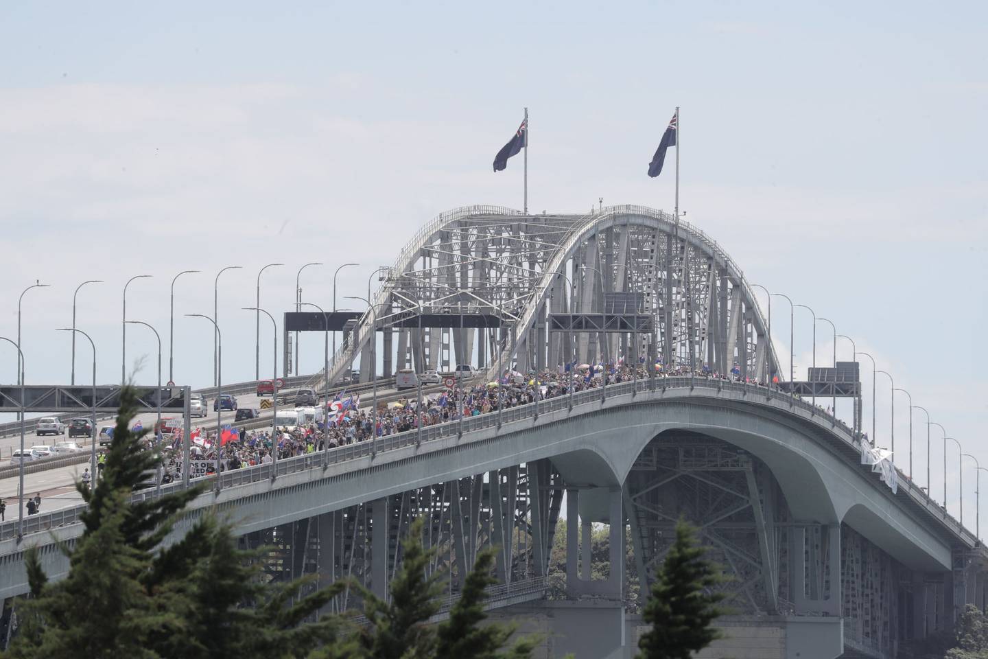 Protesters make their way over the Auckland Harbour Bridge, closing southbound lanes and reducing...